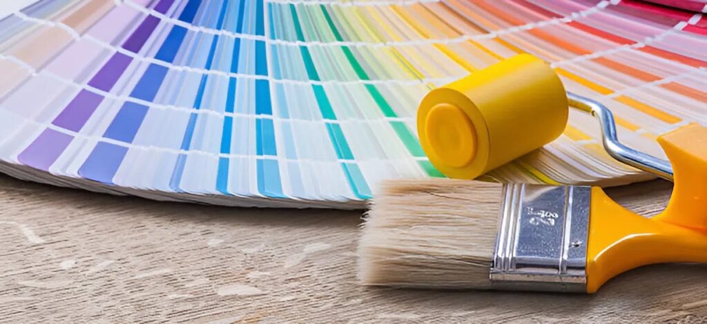 Color swatches with paint roller and brush showcasing interior color selection by a house painter in Green Hills, TN